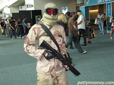 man in Camouflage holding a fake assault rifle at san diego comic con