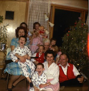 Family gathers near the Christmas tree for a portrait photo, 1962