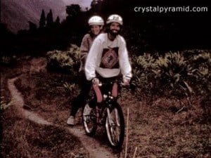 Patty and Mark mountain bike through a field of cardamom in India