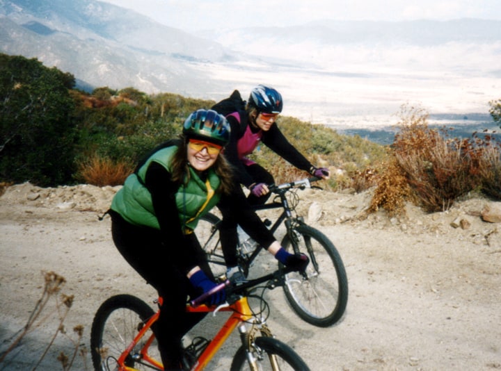 patty mooney riding klein orange mountain bike wearing green down vest julian california