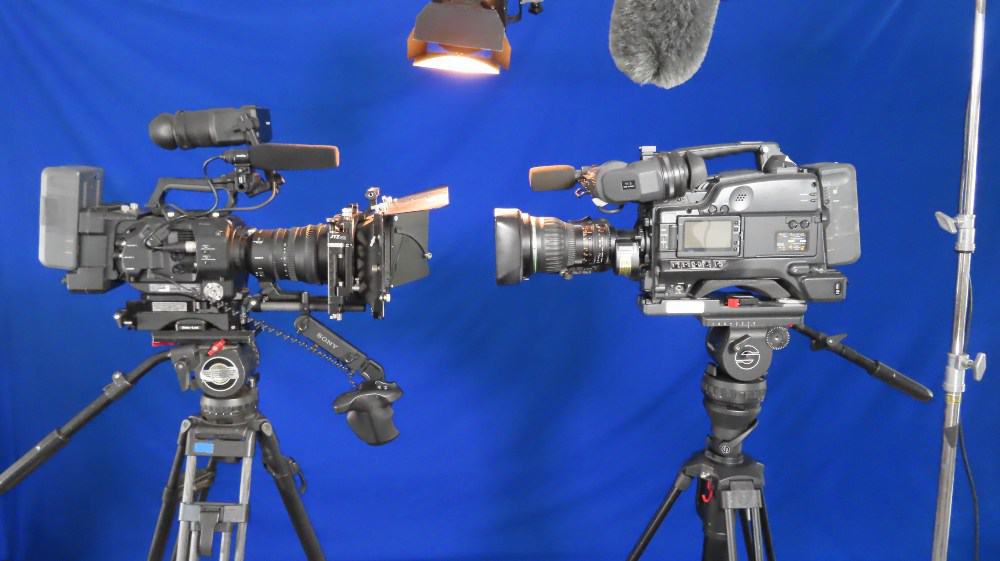 San Diego Video PRoduction - two matching sony fs7 broadcast cameras on sachtler tripods with light, boom pole and blue backdrop
