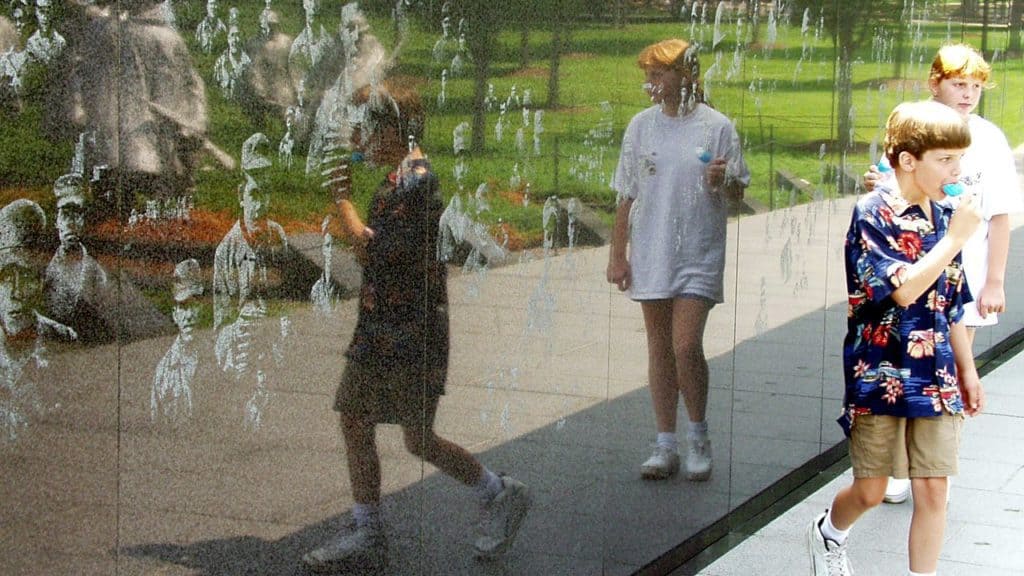 children reflected in vietnam wall