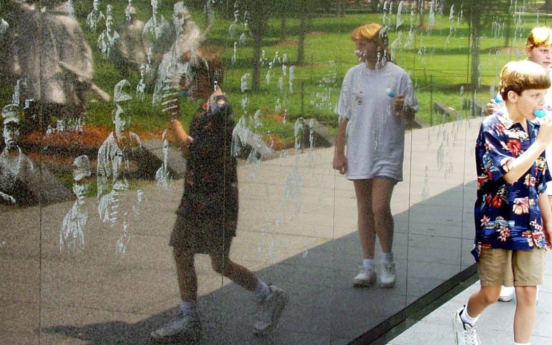 children reflected in vietnam wall