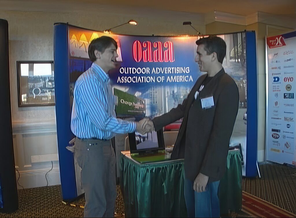 two men shake hands oaaa outdoor advertising association of america san diego convention 2007 watts wacker story