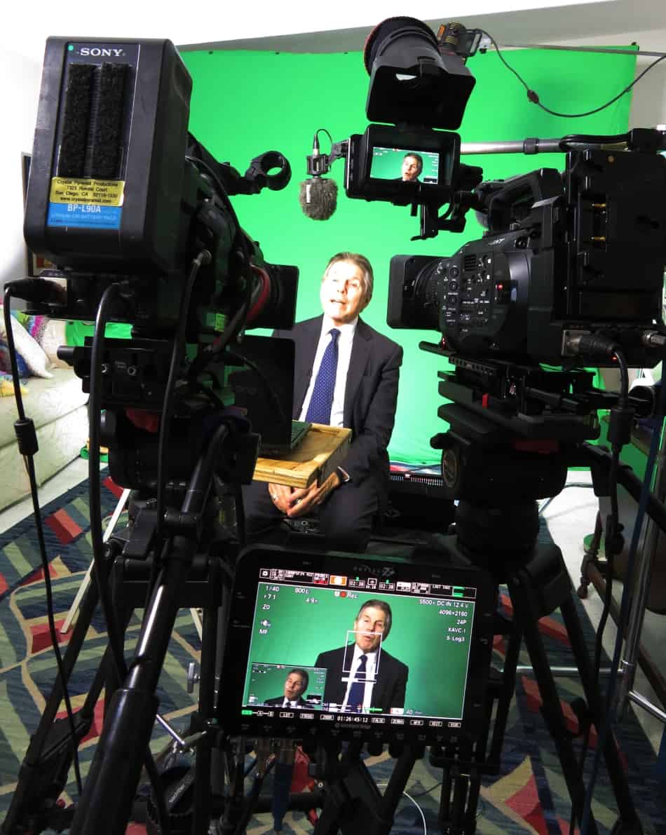 green screen interview in home studio with two cameras and monitor