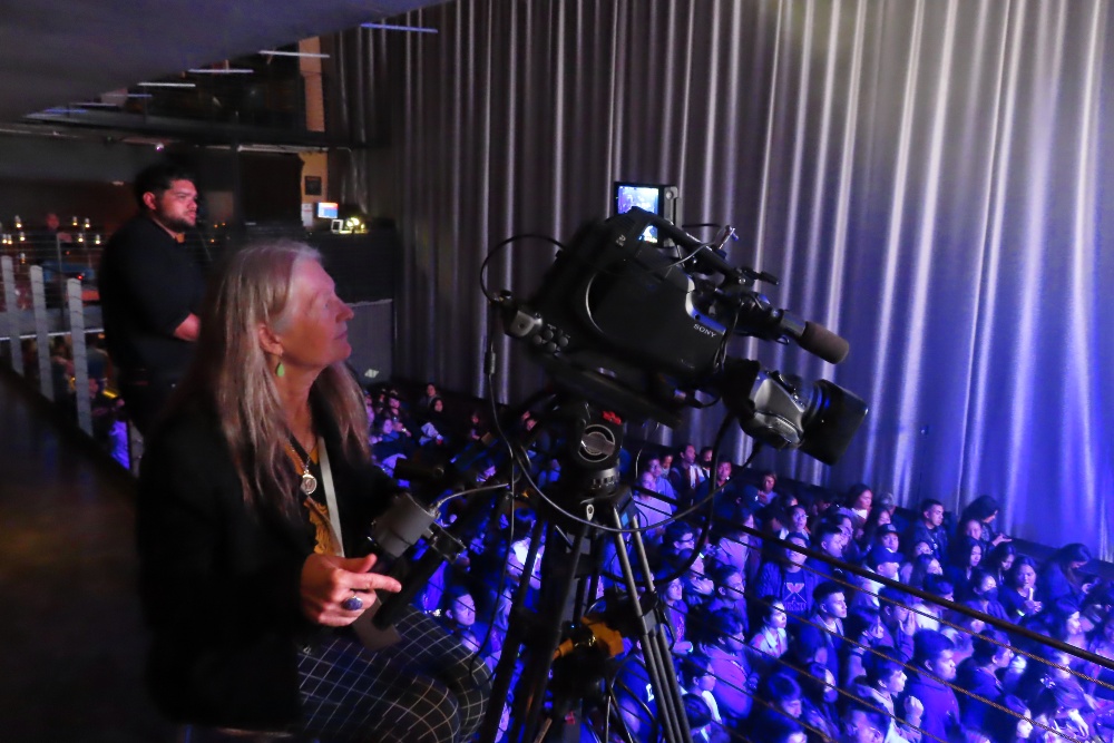 camera operator patricia mooney focuses on concert at music box in san diego
