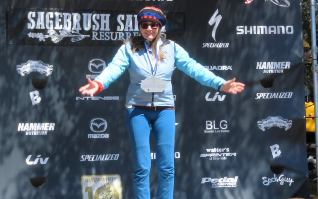 patricia mooney stands alone on podium after winning women's 20 mile mountain bike race at lake morena sagebrush safari 2023