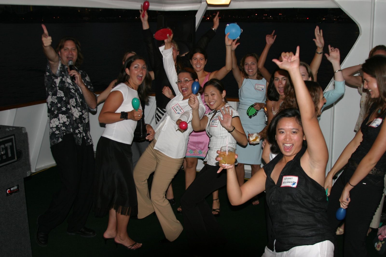 Guests with maracas and tambourines celebrating on a Hornblower cruise on San Diego Bay at an event industry gathering