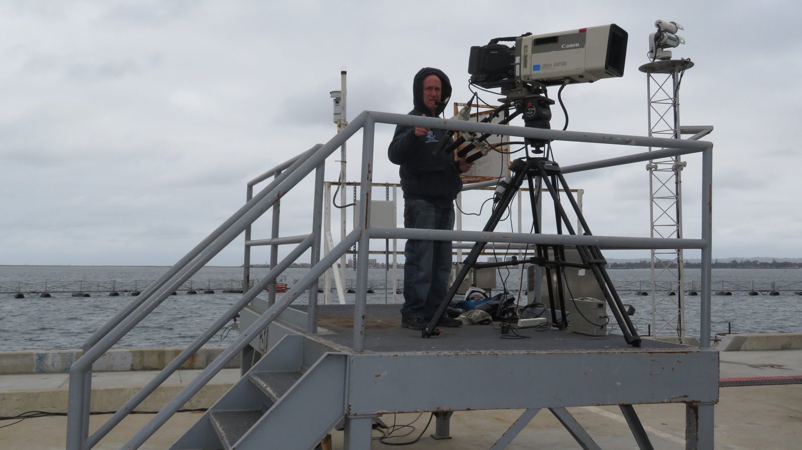 Director of photography Mark Schulze with a Canon box lens broadcast camera on a platform at the USS Bonhomme Richard decommissioning in San Diego
