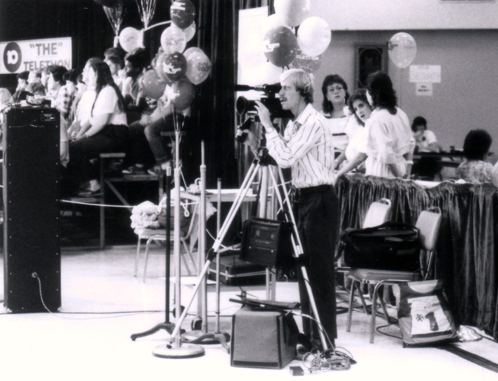 Director of photography Mark Schulze filming hypnotist Dr. Dean (Sandy Berman) at the Jerry Lewis Telethon in the early 1980s