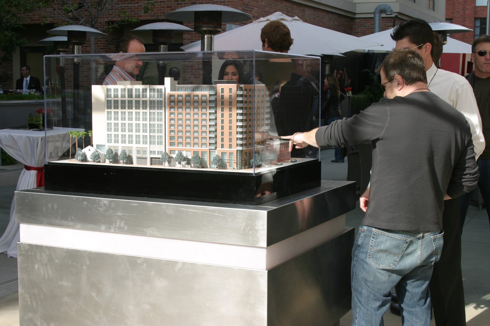 Prospective buyers study an architectural model of the San Diego Hard Rock Hotel