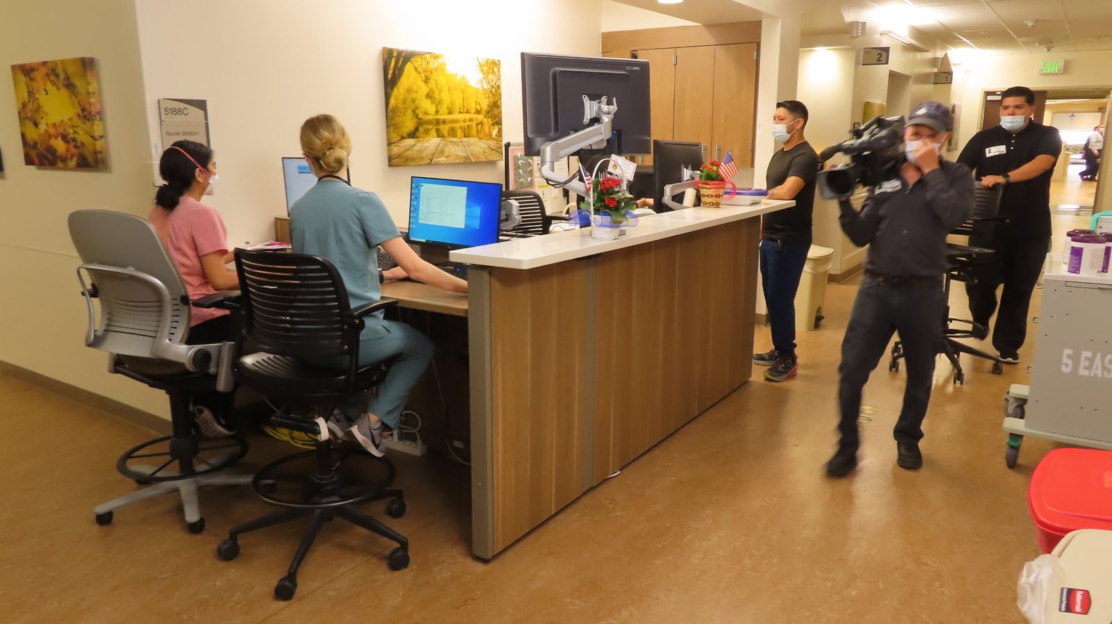 Videographer filming at a nurse station inside the VA hospital in La Jolla